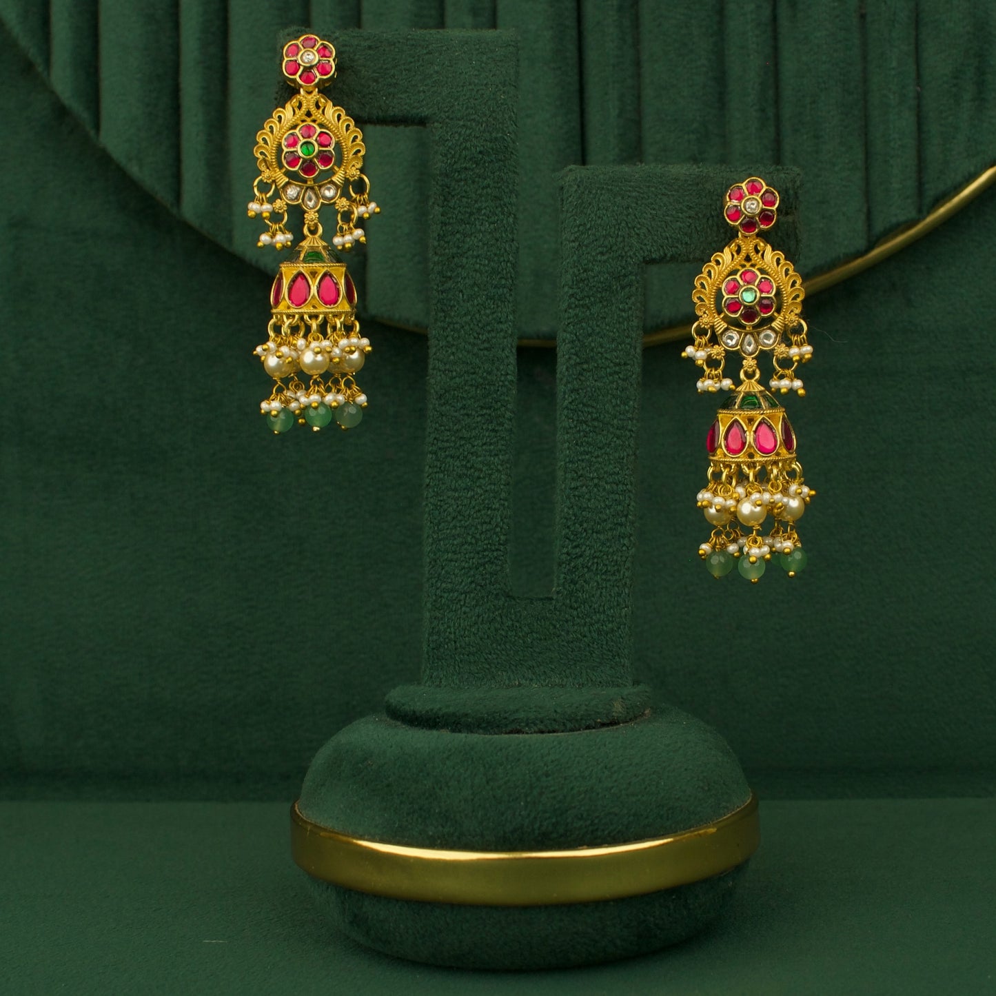 Chandbali peacock earrings in gold with red and green stones and pearl drops
