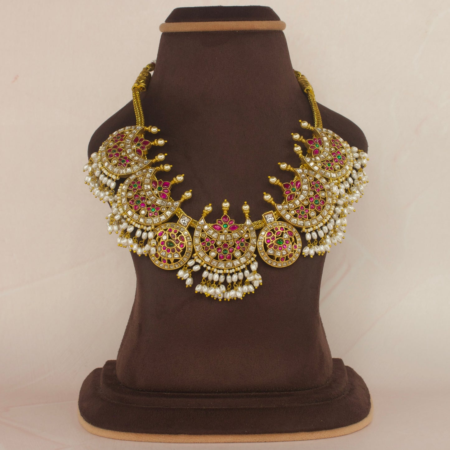 Opulent Jadau Kundan Necklace Adorned with Gleaming Rice Pearls with 22k gold plating This product belongs to Jadau Kundan jewellery category 