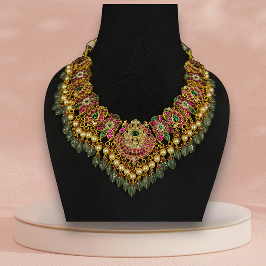 Majestic Jadau Kundan Necklace with Floral Motifs and Bead Drops with 22k gold plating This product belongs to Jadau Kundan jewellery category 