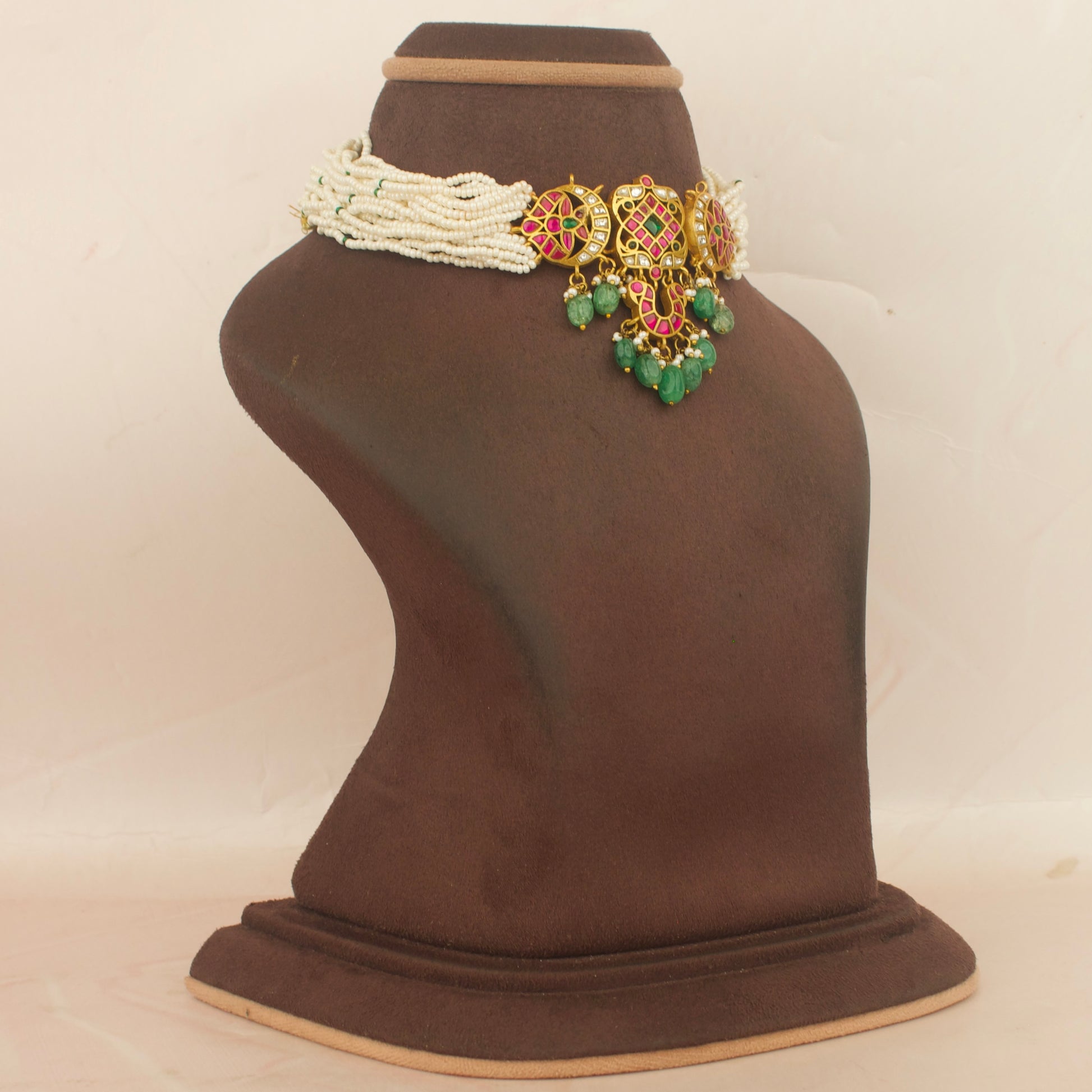 Jadau kundan choker with cream bead strands and green drop accents