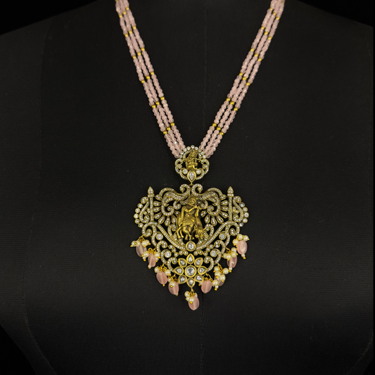 Lord Krishna Kundan Polki Beads Mala set in Antique gold finish. This Victorian Jewellery is available in a Pink colour variant. 
