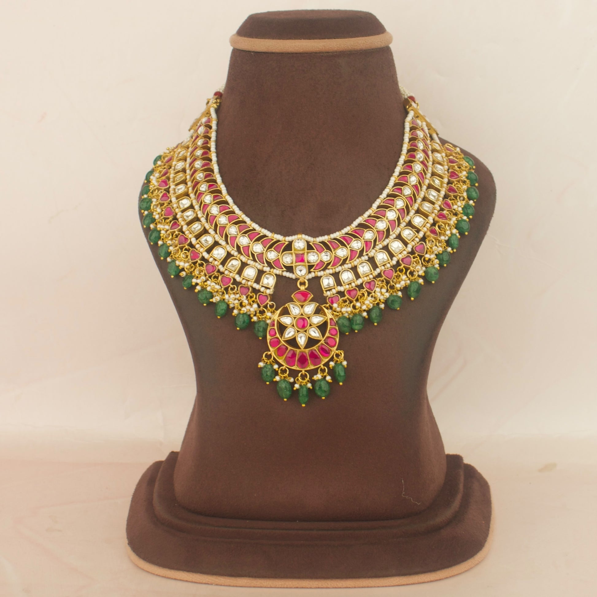 bridal layered jadau kundan necklace with red, white and green stones