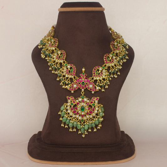 This Regal Jadau Kundan Short Necklace is covered with 22k Gold plating . There are Russian green beads at the bottom of the necklace