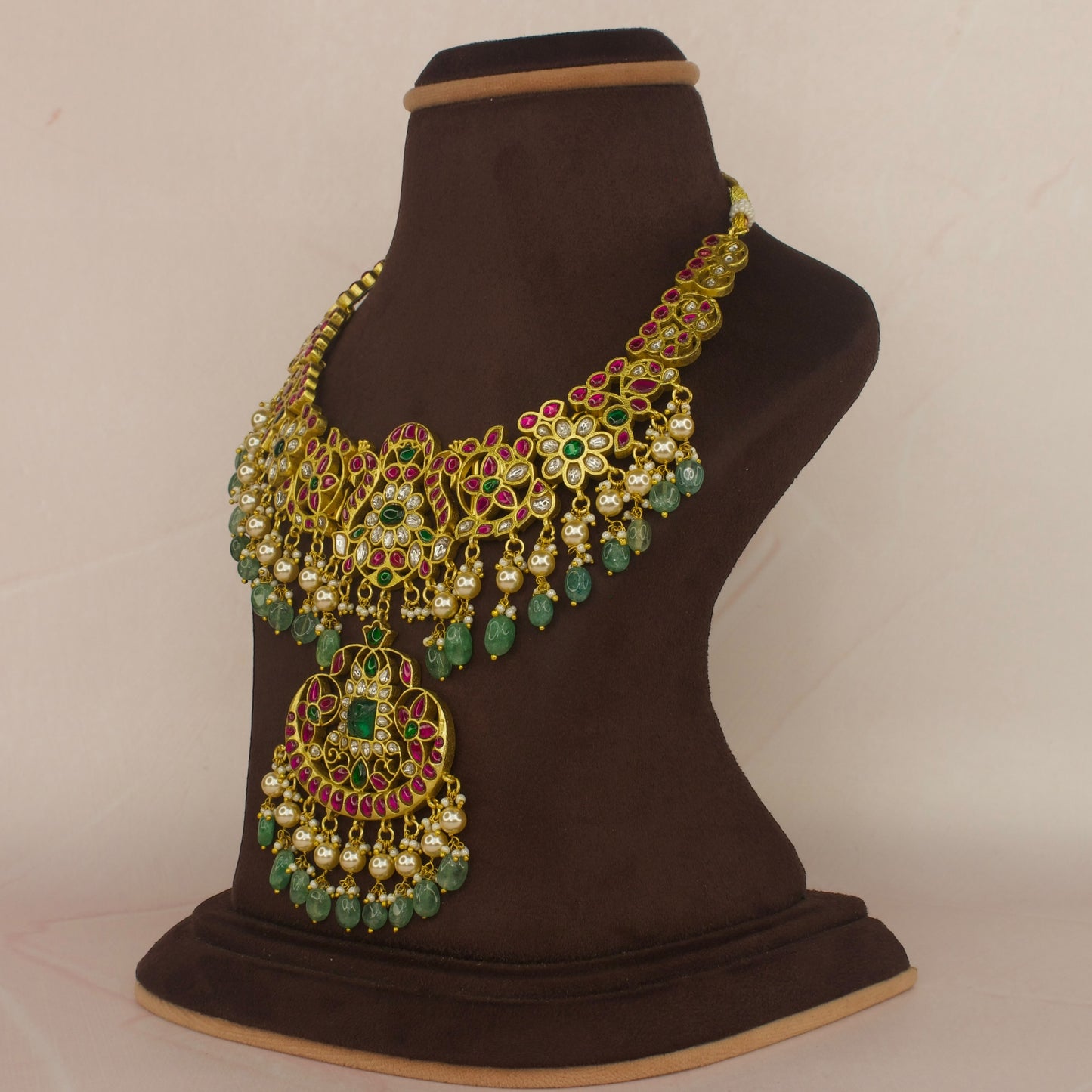 This is a Jadau Kundan Necklace with motifs on it. The piece has Pearls and Russian beads drops and 22k Gold plating