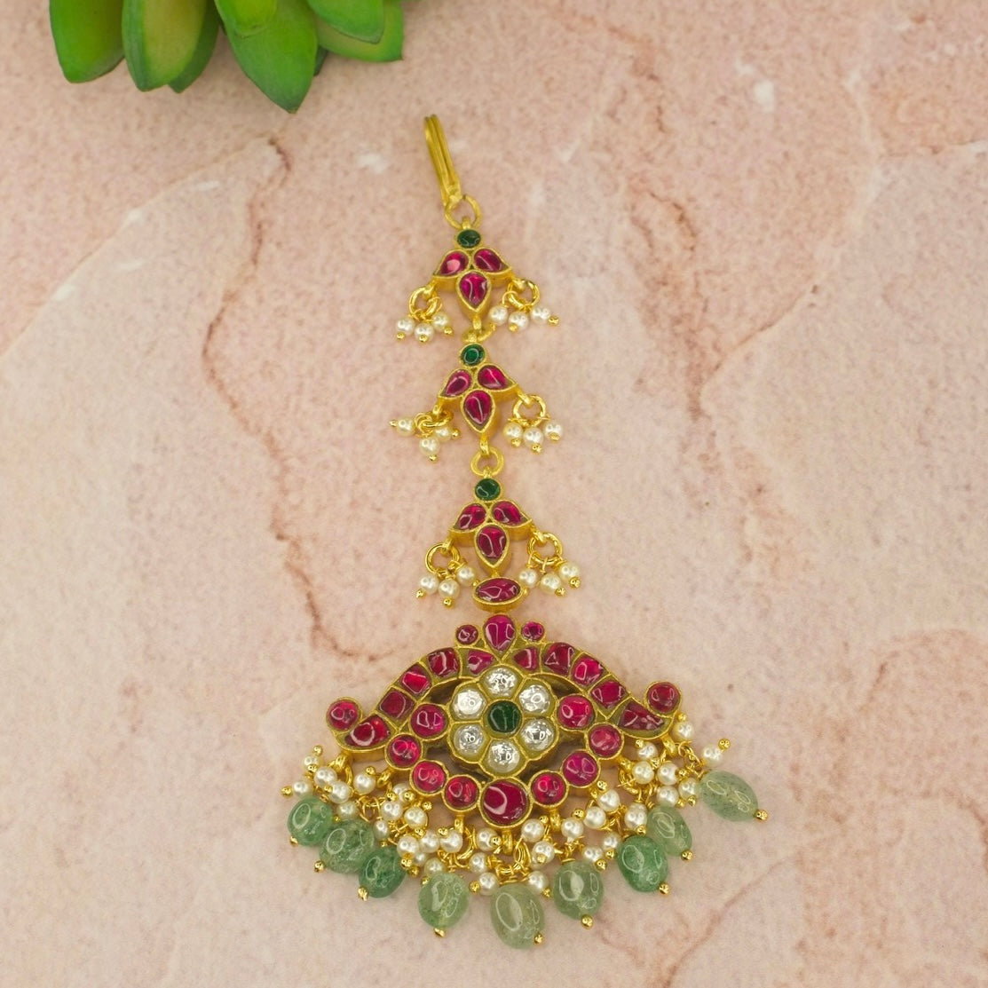 Floral & Peacock Jadau Kundan Maangtikka with 22k Gold plating . There are Russian emeralds 