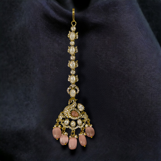Ornate Victorian Maang Tikka with peacock motifs & onyx beads. This Victorian Jewellery is available in a Pink colour variant. 