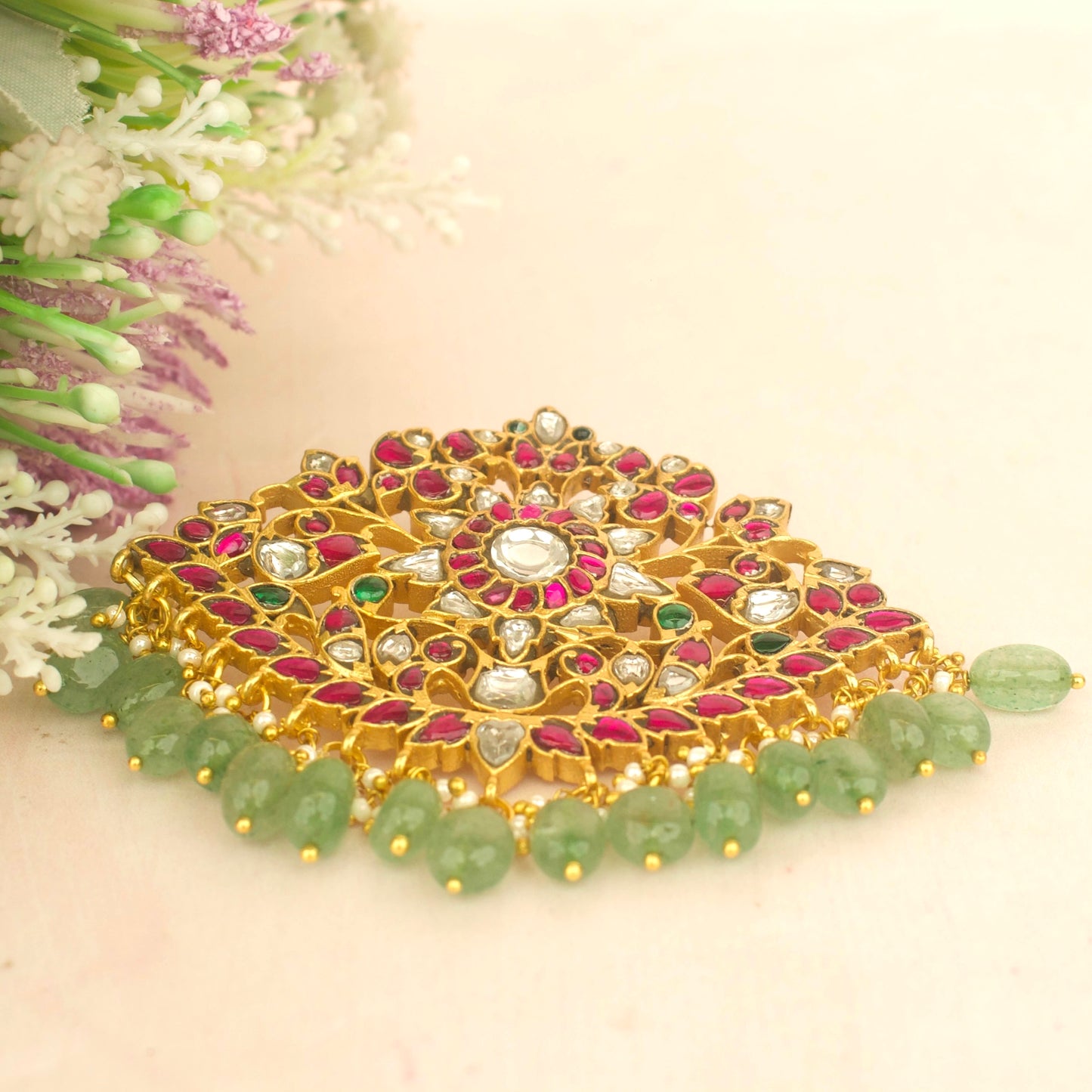 Jadau kundan gold locket with green beads