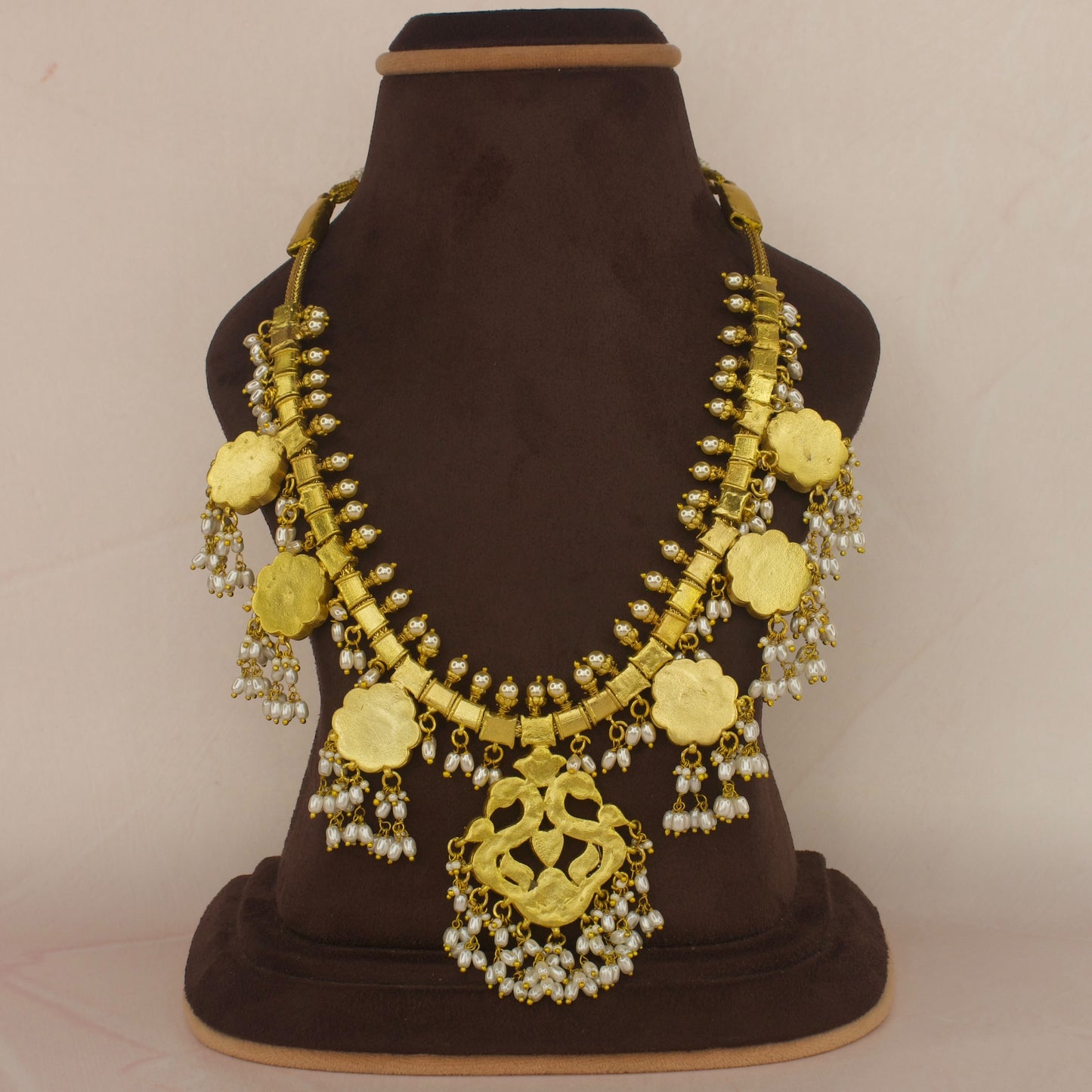 This is a Jadau Kundan Rice pearl Guttapusalu necklace with Peacock and Flower motifs. It’s covered in 22k Gold plating