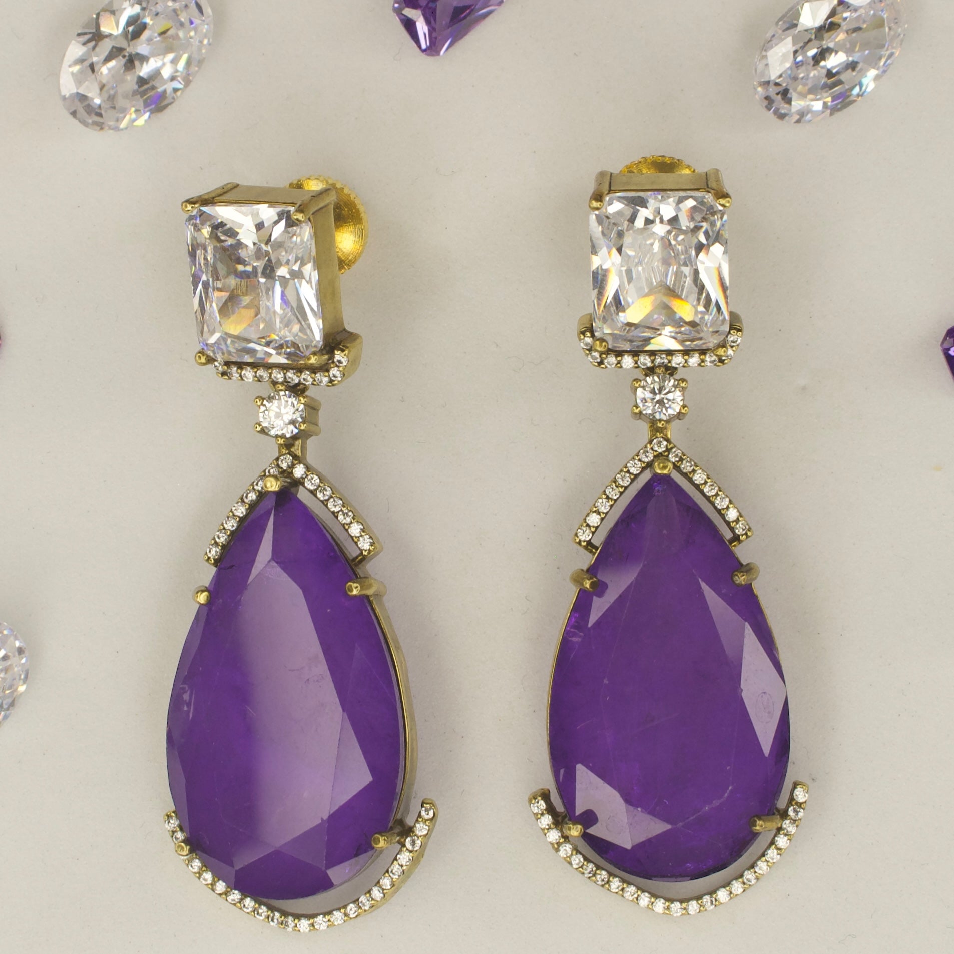 Fancy yet classic stone hanging earrings with victorian finish available in red, green, purple & mint