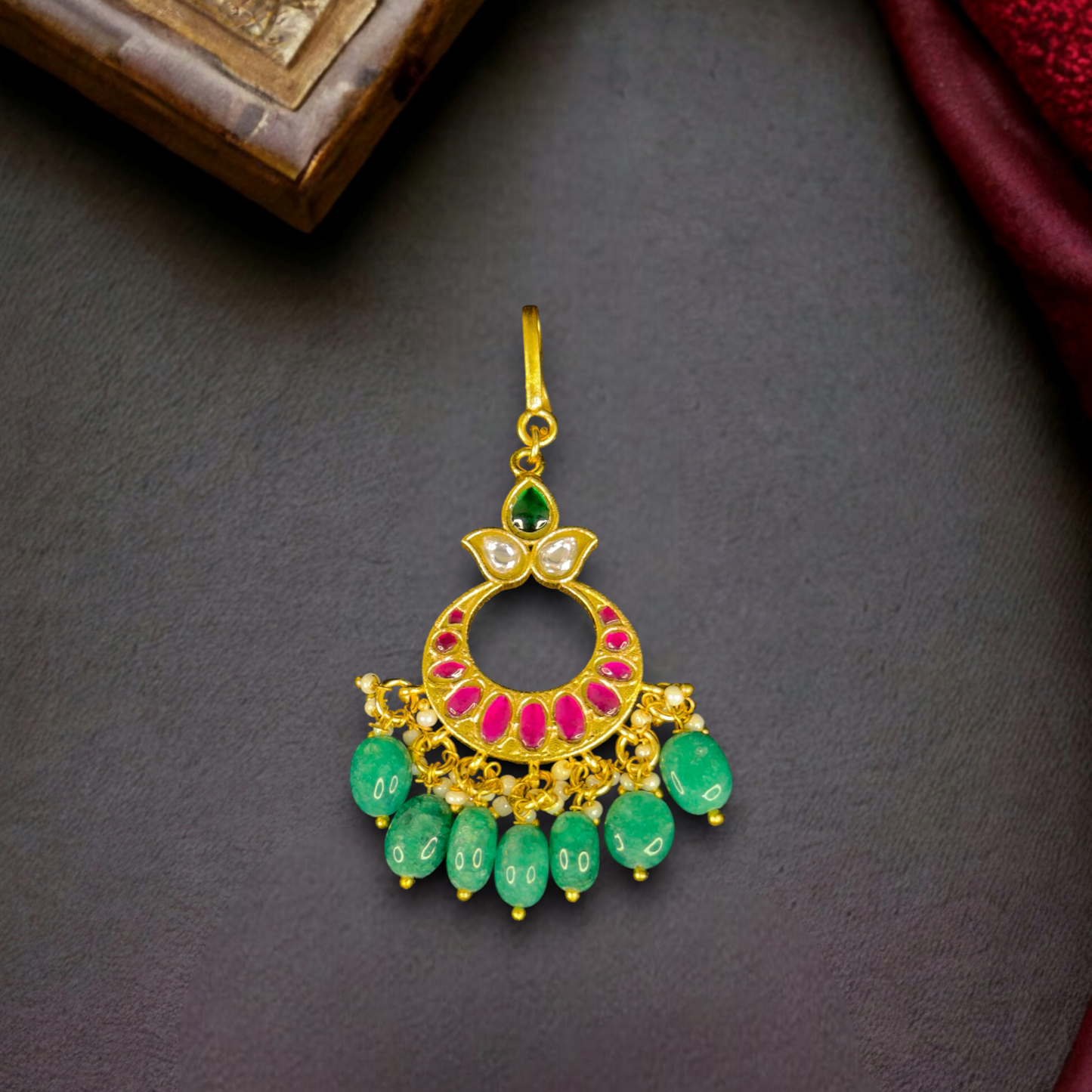 Classic Jadau Kundan Maangtika With Pearls And Green Beads in 22k gold plating. this product comes under jadau kundan collection