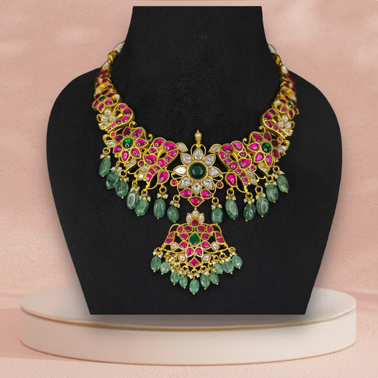 Opulent Jadau Kundan Necklace with Intricate Floral Design and Green Drops with 22k gold plating This product belongs in jadau kundan jewellery category