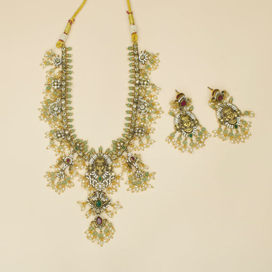Sacred Guttapusalu Victorian Necklace set with zircons, pearls, and beads, including matching earrings. This Victorian Jewellery is available in a Red colour variant. 
