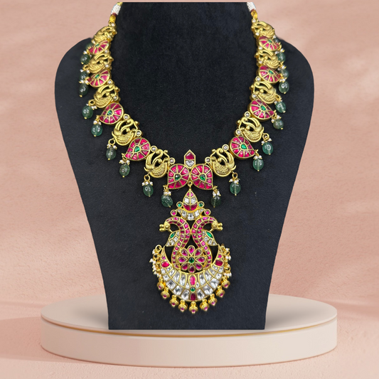 Opulent Jadau Kundan Mango Necklace with Emerald and Ruby Highlights with 22c gold platingThis product belongs to Jadau Kundan jewellery category 