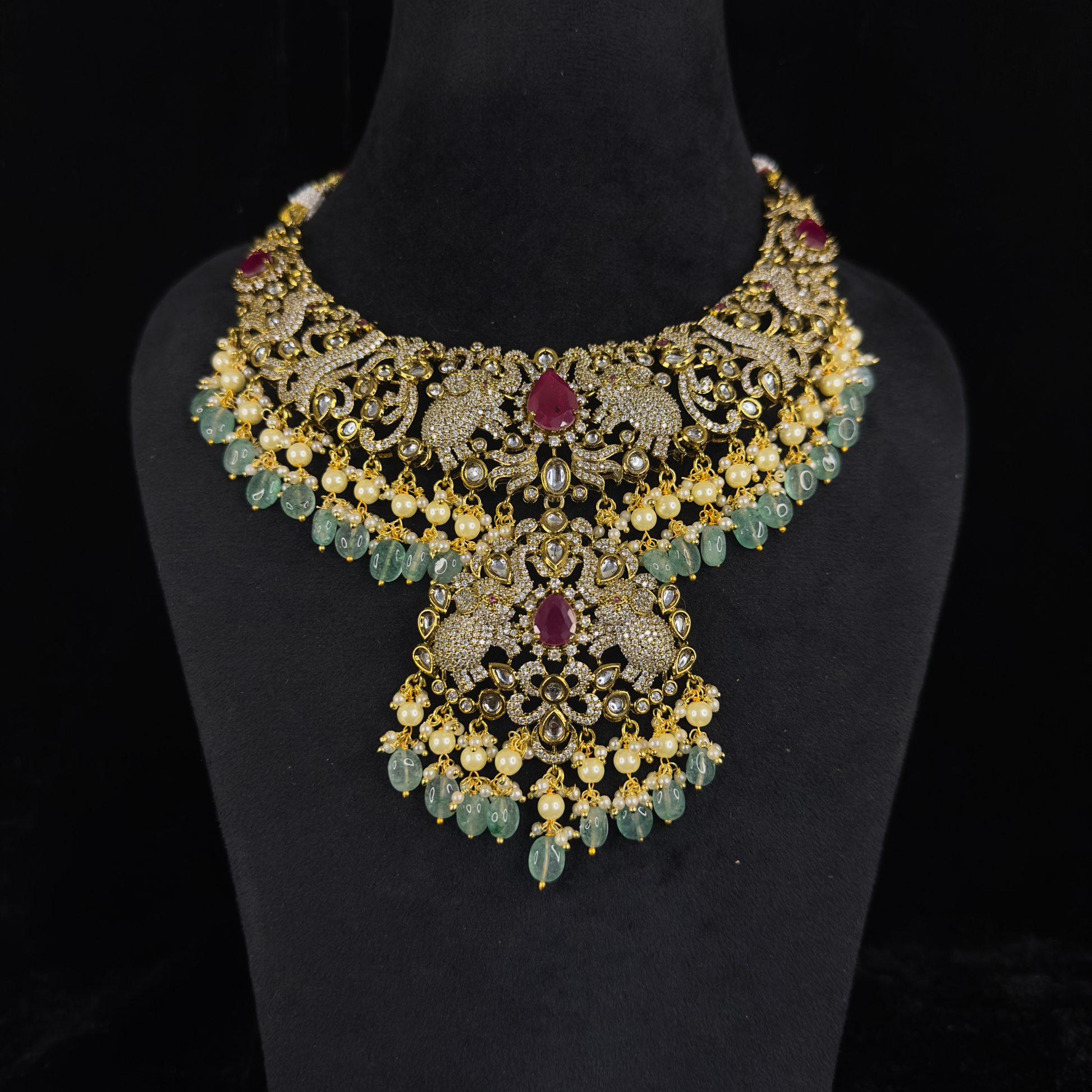 Beautiful Victorian Necklace Set with zircon, moissanite polki stones, elephant & peacock motifs, pearls, and beads, including matching earrings. Available in a red colour variant.