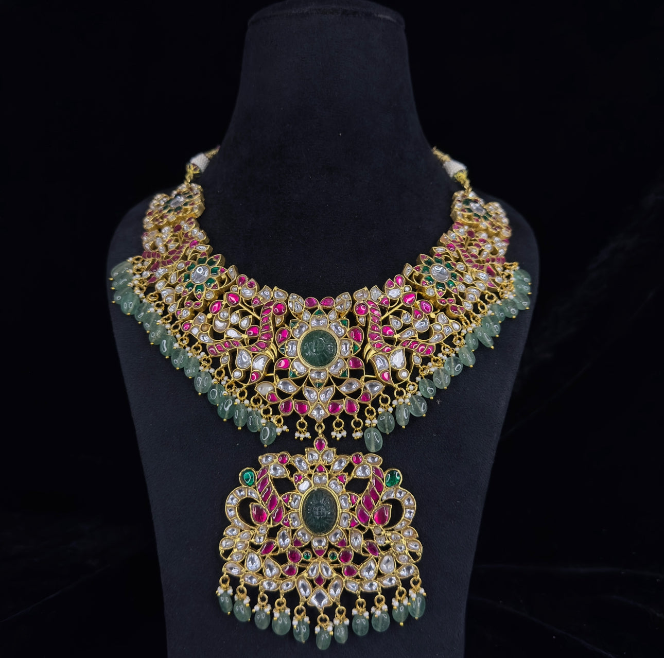 Regal Peacocks Jadau Kundan Necklace with Emerald and Ruby Accents with 22k gold platingThis product belongs to Jadau Kundan jewellery category 