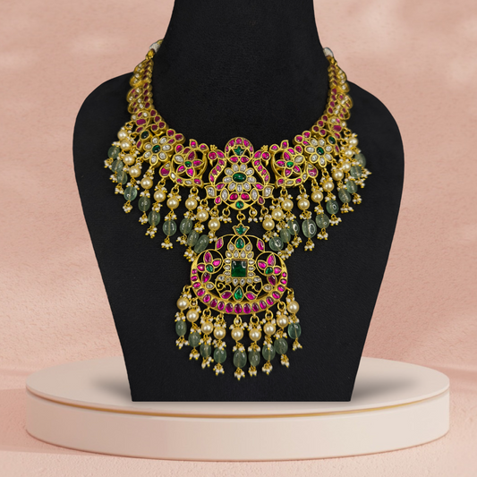 Opulent Jadau Kundan Necklace with Majestic Pearl and Emerald Accents with 22k gold platingThis product belongs to Jadau Kundan jewellery category 