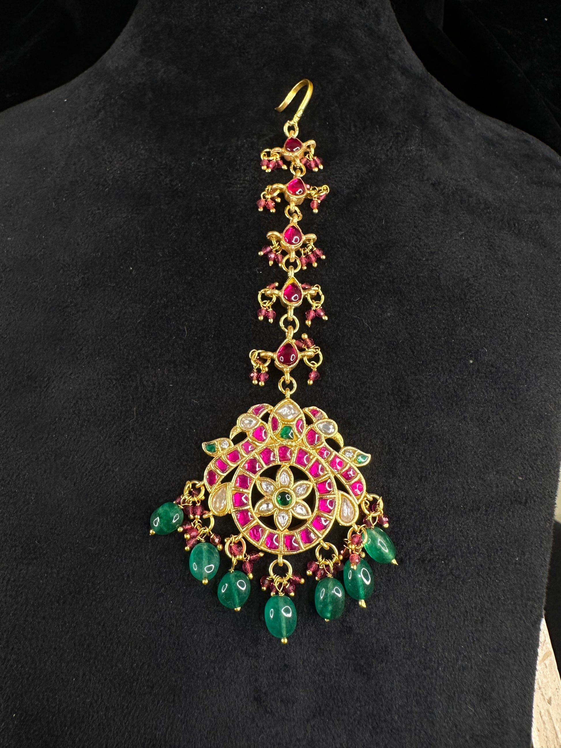 Elegant Jadau Kundan Maang Tikka with Ruby and Emerald Drops with 22k gold platingThis product belongs to Jadau Kundan jewellery category