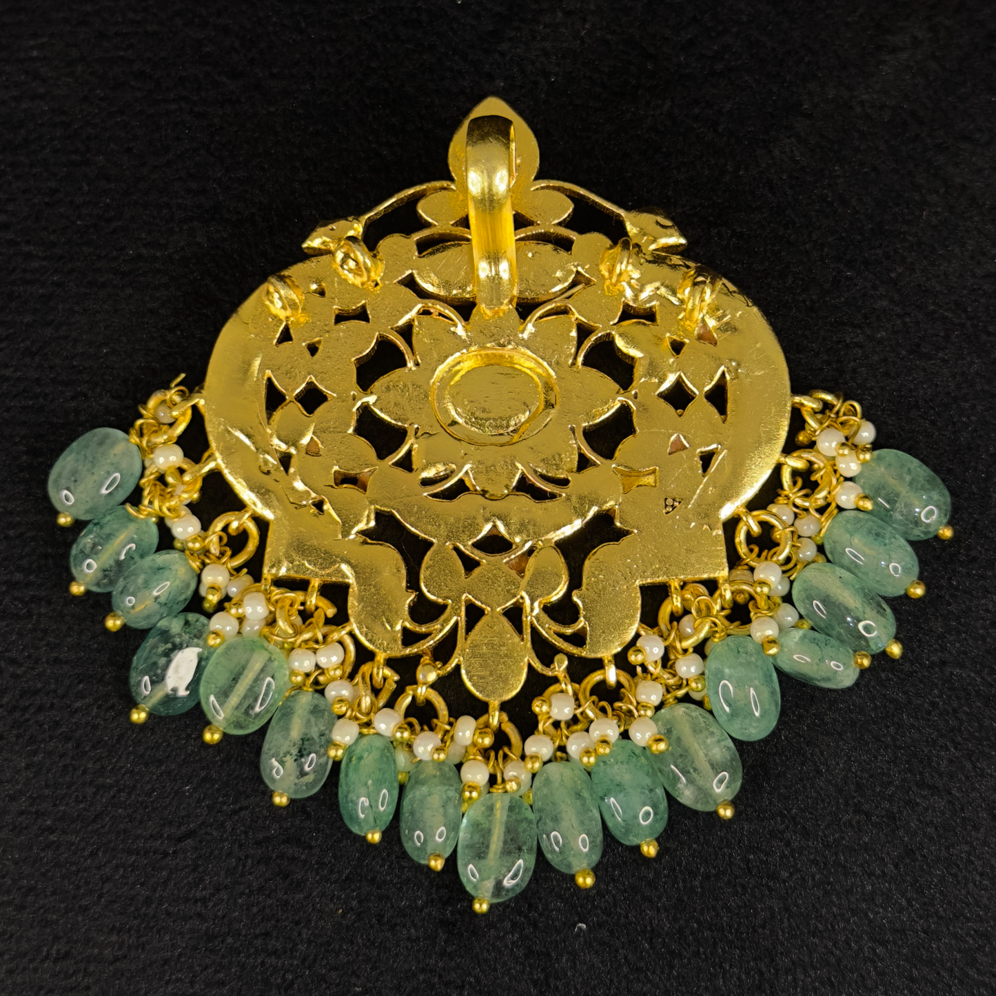 Here is Our Jadau Kundan pendant With motifs of 2 Peacocks with a Flower in the middle. This is 22k Gold plated pendant with Russian emerald beads at bottom