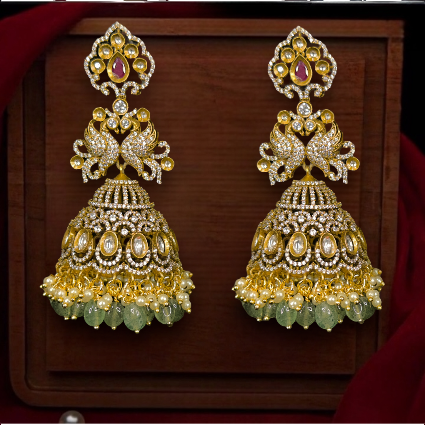 Victorian Peacock Jhumkas with zircon & pearls. This Victorian Jewellery is available in a Red colour variant. 