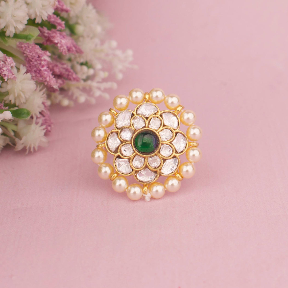 Premium gold Floral Polki Statement Ring With Emerald Center And Pearl Border adorned with ruby