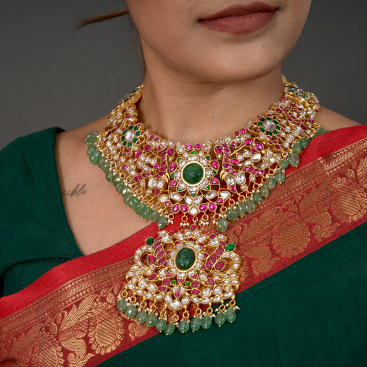 Regal Peacocks Jadau Kundan Necklace with Emerald and Ruby Accents with 22k gold plating This product belongs to Jadau Kundan jewellery category