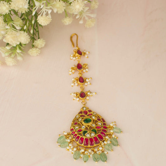 Chandbali Shaped Jadau Kundan Maangtika with intricate design and vibrant colors, perfect for festive occasions.