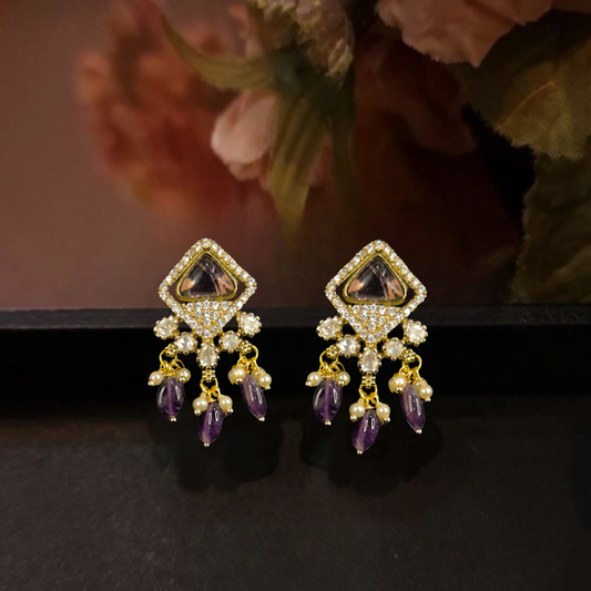 Kite shaped Victorian polki Studs with onyx beads & pearl drops. This Victorian Jewellery is available in a Purple colour variant. 
