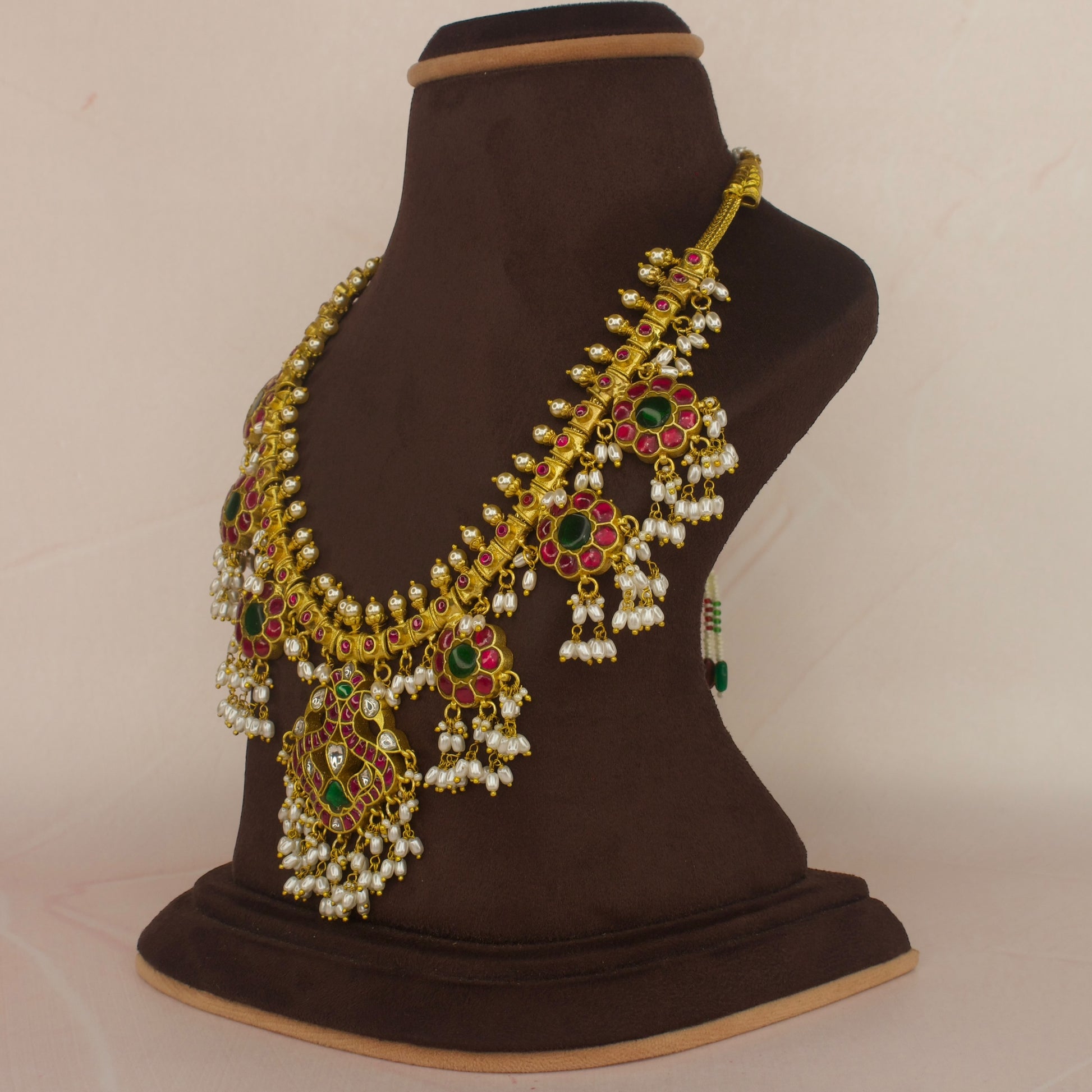 This is a Jadau Kundan Rice pearl Guttapusalu necklace with Peacock and Flower motifs. It’s covered in 22k Gold plating