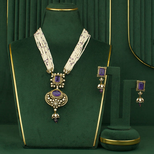 royal chandbali necklace and earrings set with purple stones and white beads