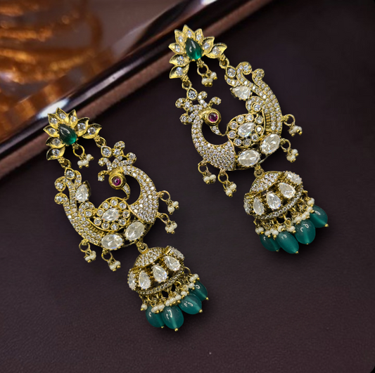 Victorian Chandbali x Jhumka Fusion Earrings with peacock motif design, moissanite polki stones, zircon stones, pearls and beads. This Victorian Jewellery Is available in Red & Green colour varaiants. 