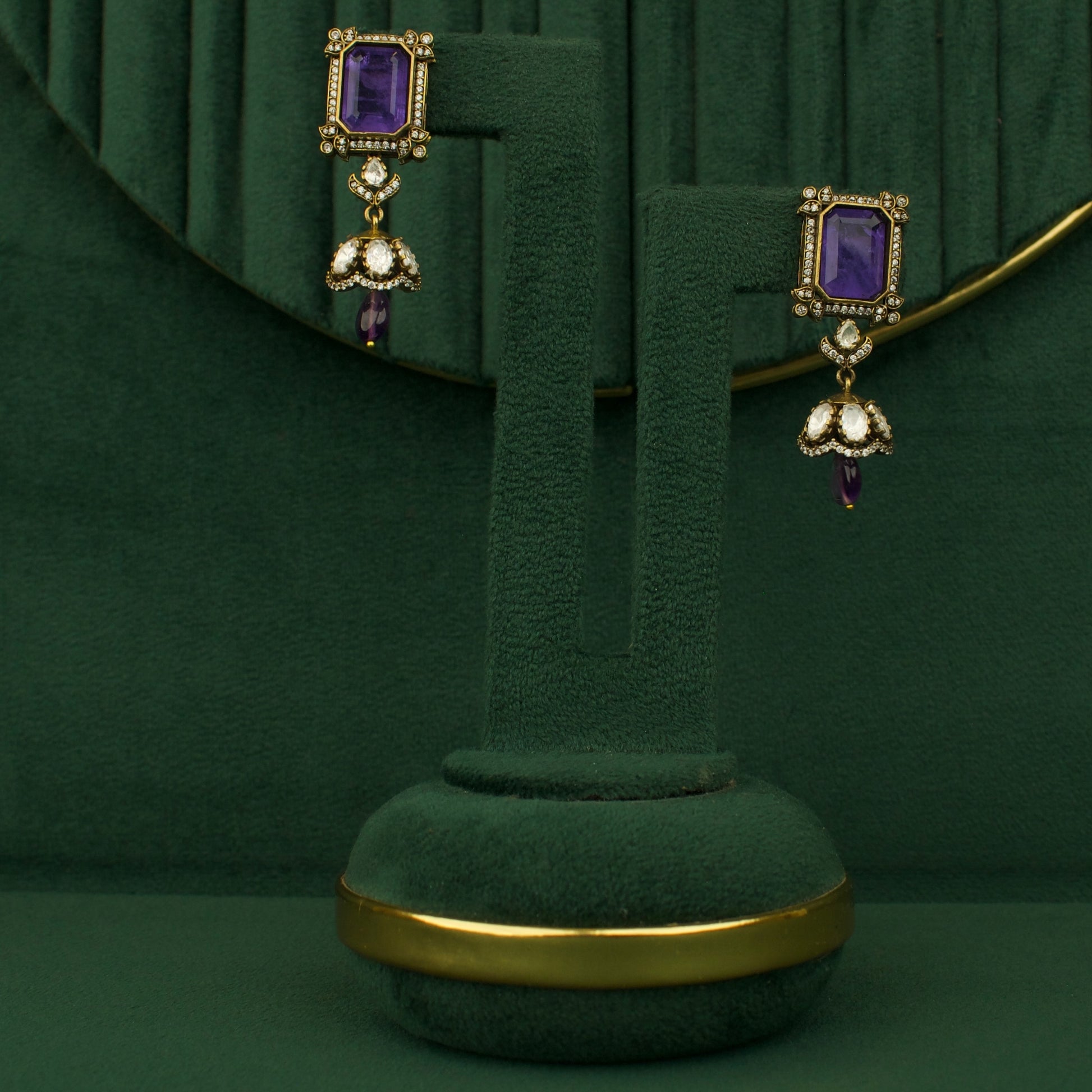 Chandbali earrings pair with purple stones and gold-tone bead drops