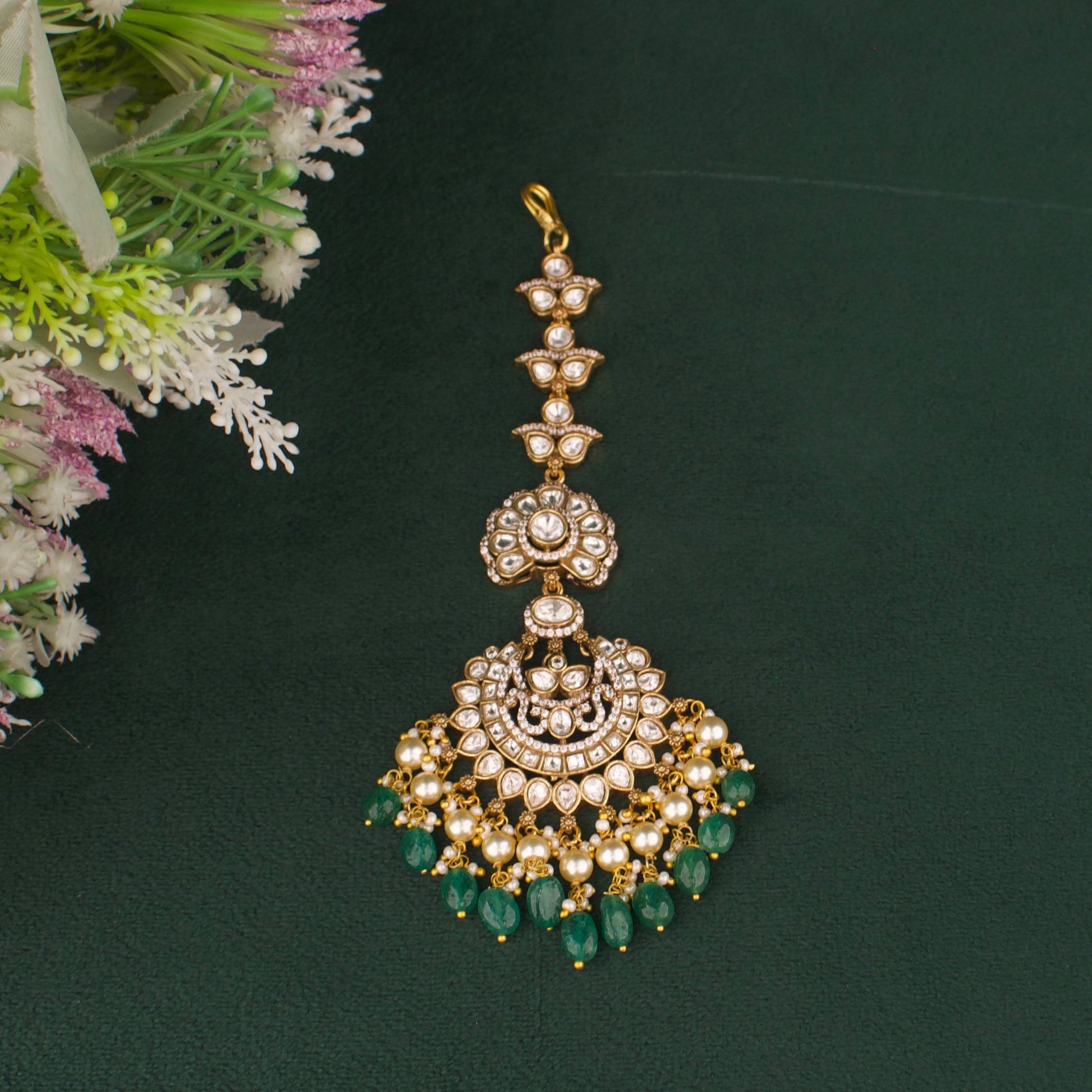 Close-up detailing of Elegant Victorian Maang Tikka With Pearl And Emerald Hangings