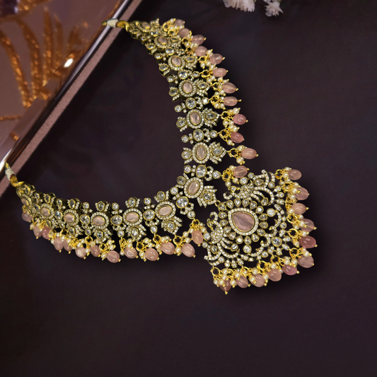 Traditional Victorian Necklace Set with screw-back earrings with zircon, kundan polki stones, peacock motif, pearls, and beads, including matching earrings. This Victorian Jewellery is available in a baby pink colour variant. 