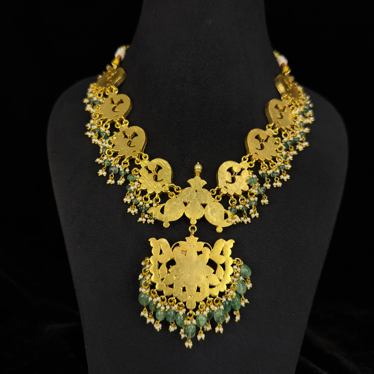 Radiant Peacock Motif Jadau Kundan Necklace with Emerald Drops with 22k gold plating. This product belongs to jadau kundan jewellery category