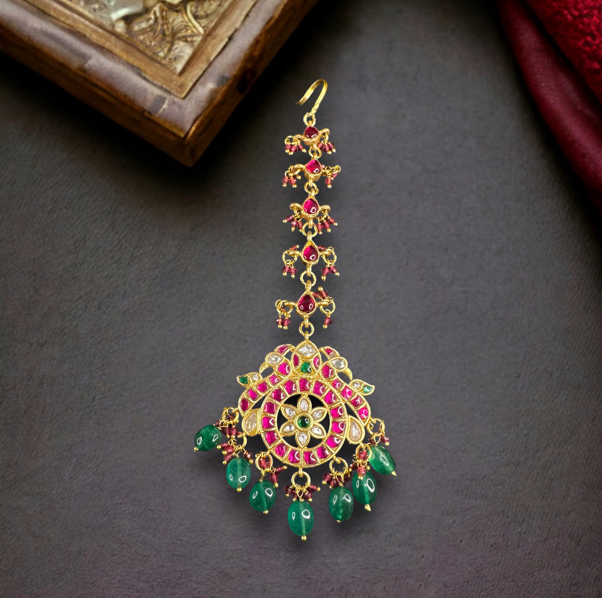 Elegant Jadau Kundan Maang Tikka with Ruby and Emerald Drops with 22k gold platingThis product belongs to Jadau Kundan jewellery category