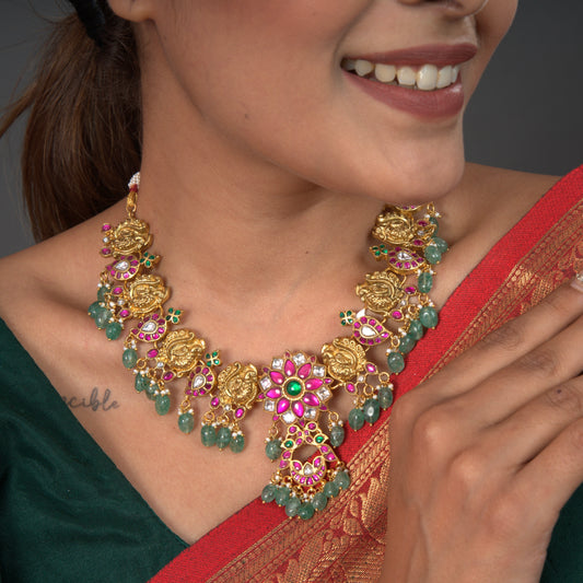 Radiant Blossom: Jadau Kundan Necklace with Floral Motifs and Emerald Drops with 22k Gold Plating This product belongs to jadau kundan jewellery category
