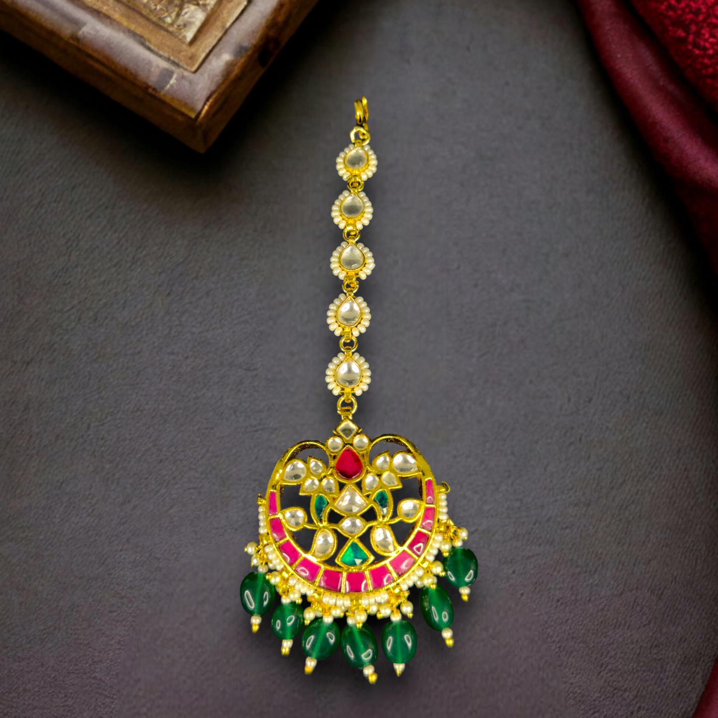 chandbali design  Bridal Maangtika WIth Dark Green Beads  in 22k gold plating. this product comes under jadau kundan collection