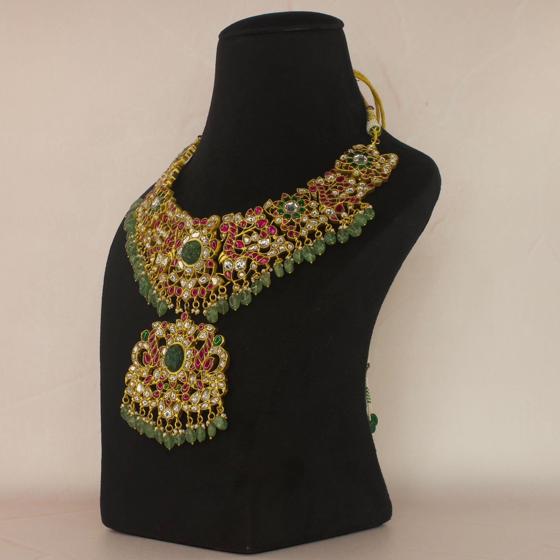 Regal Peacocks Jadau Kundan Necklace with Emerald and Ruby Accents with 22k gold plating This product belongs to Jadau Kundan jewellery category