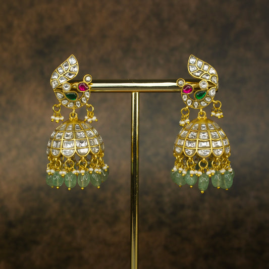 Beautiful Jadau Jhumka design in a 22k gold plating with uncut white kundans, pearls, and beads.