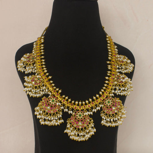 Opulent Guttapusulu Jadau Kundan Necklace with Pearl Tassels and Floral Accents with 22k gold platingThis product belongs to Jadau Kundan jewellery Category