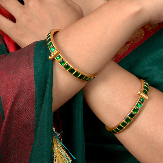 Luxurious Emerald Jadau Kundan Bangles in 22k gold plating This product belongs to Jadau Kundan jewellery category 