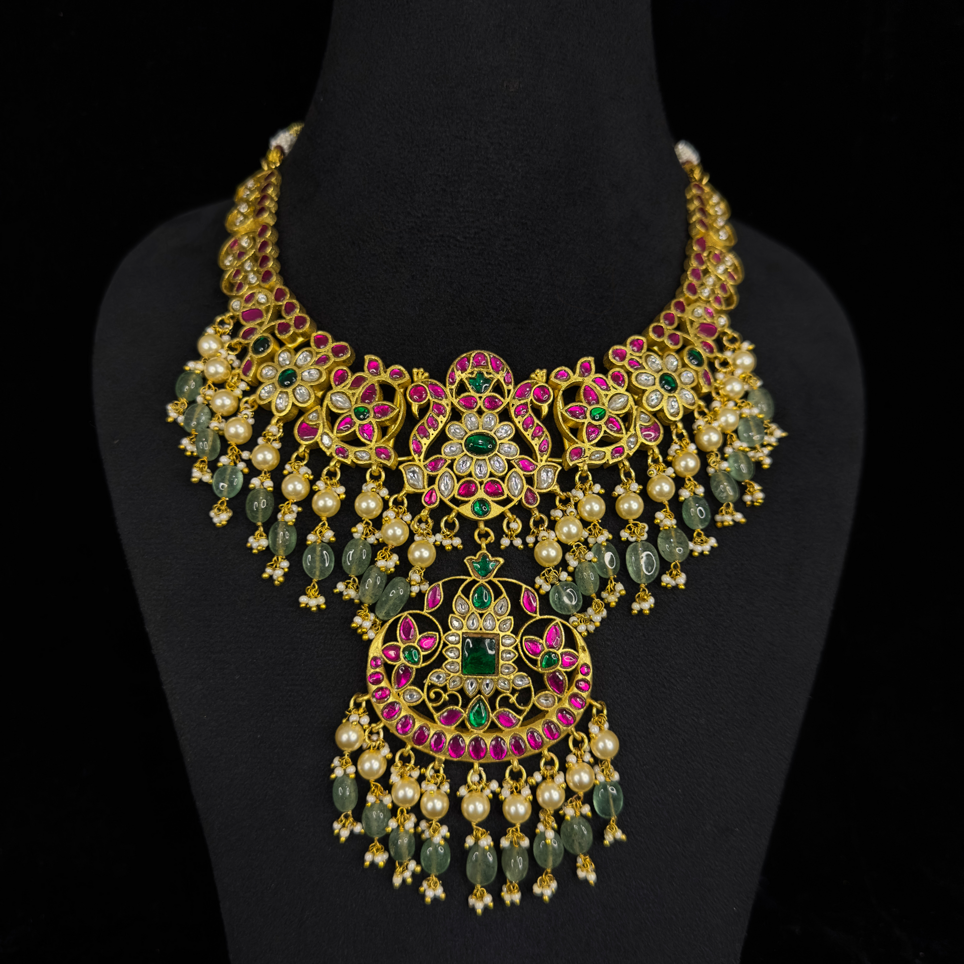 This is a Jadau Kundan Necklace with motifs on it. The piece has Pearls and Russian beads drops and 22k Gold plating