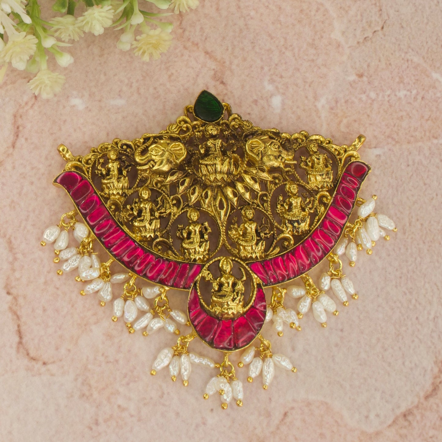 This is a Nakshi finished Pendant with Jadau Kundan work on it. This pendant has 8 Motifs of Goddess Lakshmi and at the bottom of the pendant we have Ricepearls