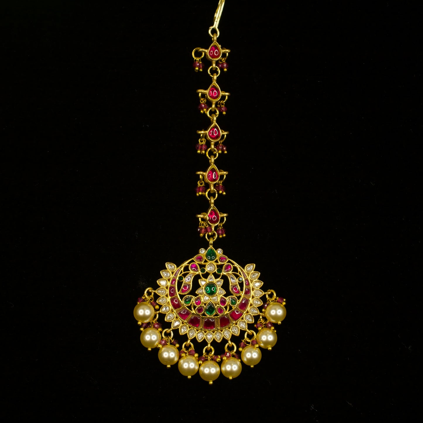 Traditional Jadau Kundan Maang Tikka with Pearl and Ruby Beads with 22k gold plating This product belongs to Jadau Kundan jewellery category