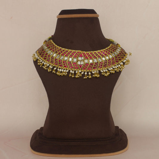 This is a Jadau Kundan Choker cum short necklace with rice pearls at bottom. This piece is covered in 22k Gold plating