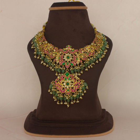 Here is our Beautiful Jadau Kundan Necklace in Multi colour with Floral designs all over it. At the bottom of necklace we have Russian emeralds with pearls and the Neckpiece is covered with 22k Gold plating