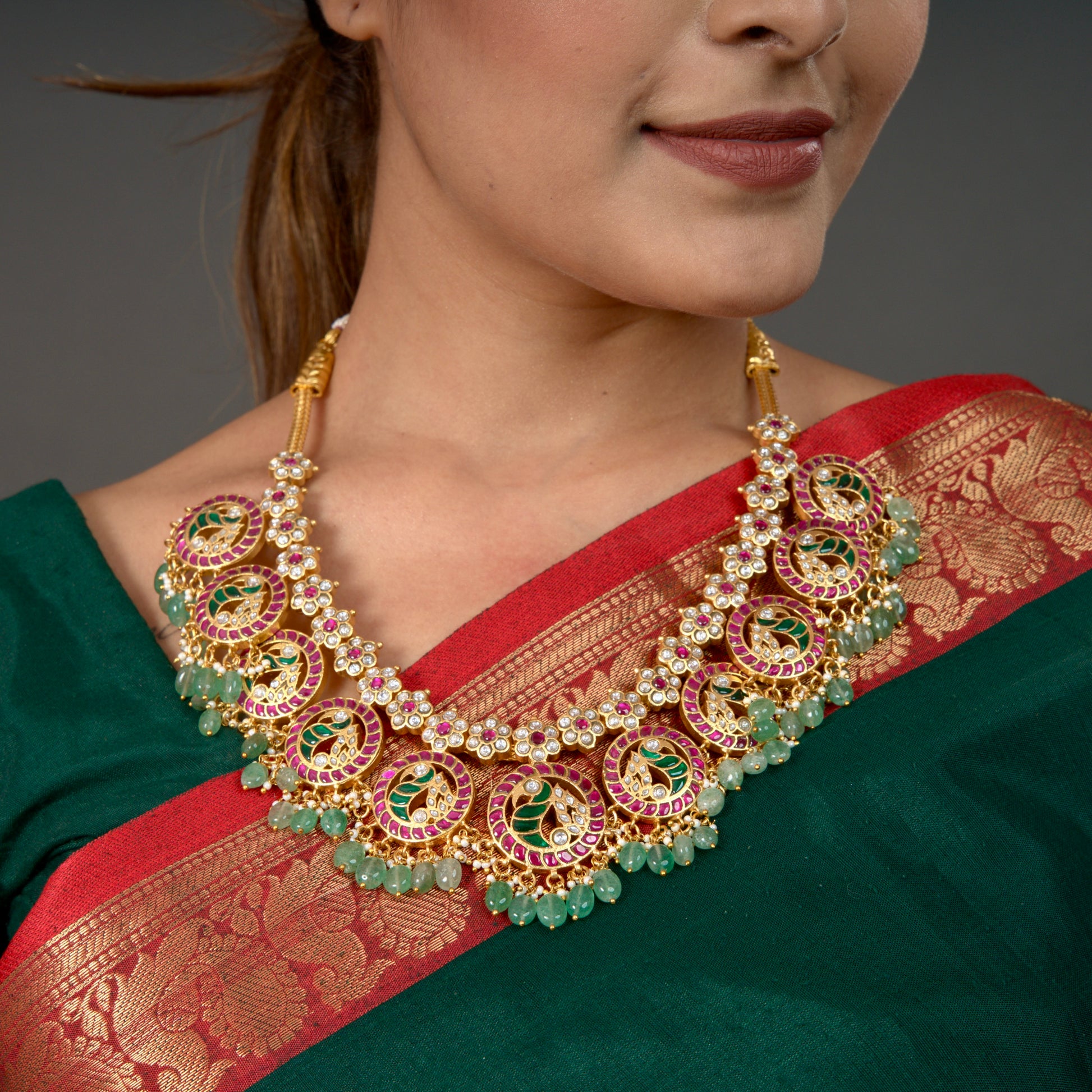 "Opulent Jadau Kundan Bottumala Necklace with Emerald and Ruby Accents in 22k gold platingThis product belongs to Jadau Kundan jewellery category 