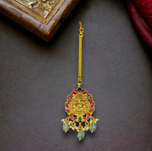 Lord Ganesha Jadau Kundan Maang Tikka in 22k gold plating. this product comes under jadau kundan collection