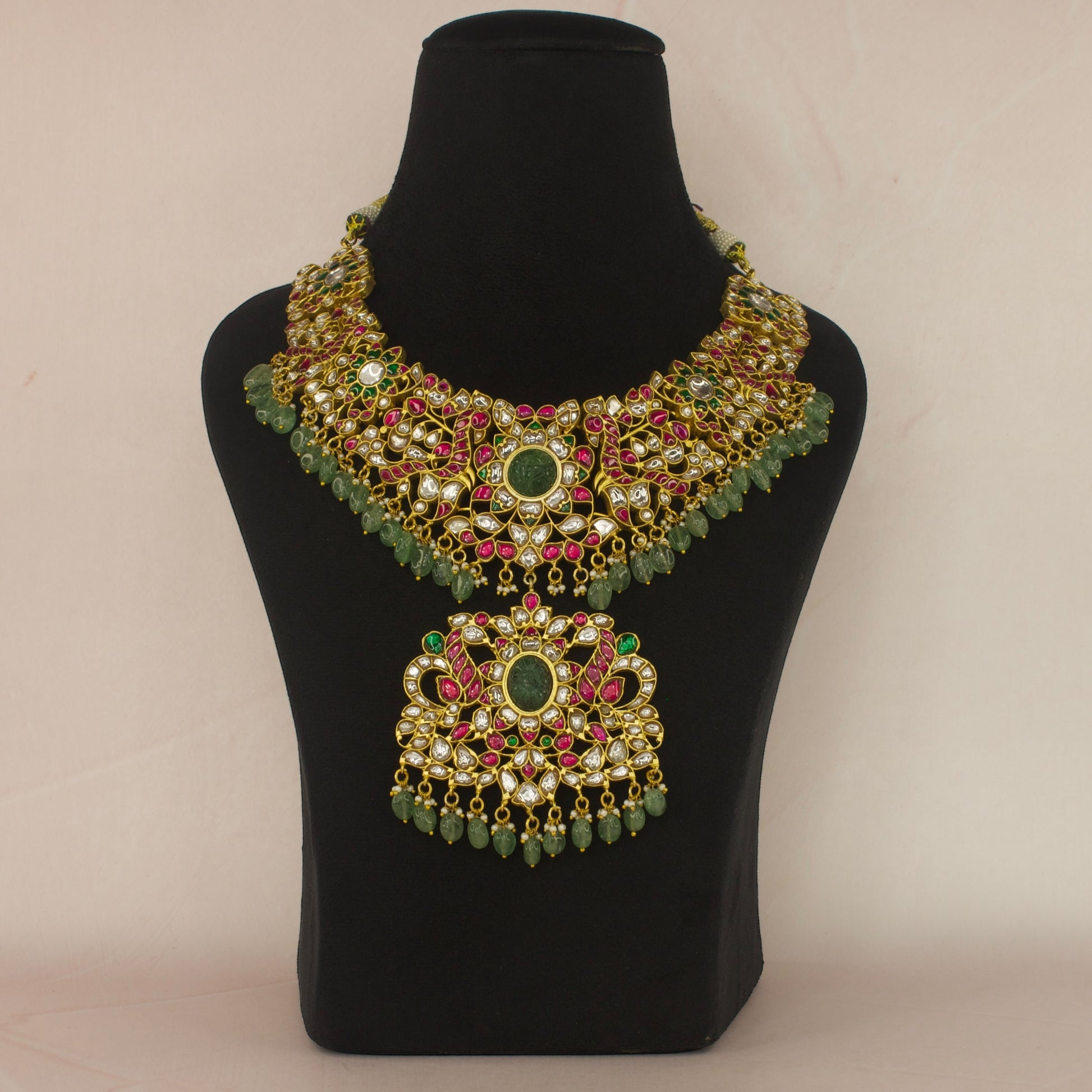 Regal Peacocks Jadau Kundan Necklace with Emerald and Ruby Accents with 22k gold plating This product belongs to Jadau Kundan jewellery category