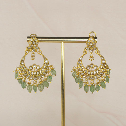 White Jadau Kundan Chandbali with Russian Emerald Beads with 22k gold plating. This product belongs to jadau Kundan jewellery